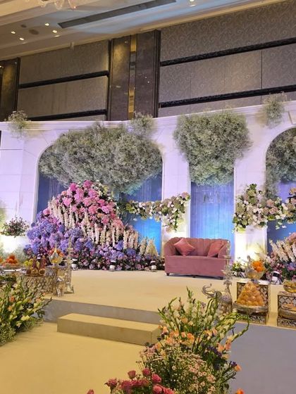 A wide shot of the pastel floral stage, capturing the full architectural and floral design.