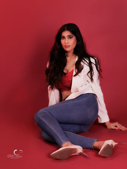 A more dynamic and alluring floor pose. The composition is strong, and her expression is full of confidence.