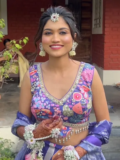 The bride looks joyful and vibrant, with a unique ponytail that matches the playful energy of her pre-wedding celebrations.