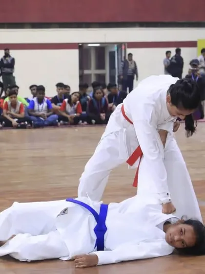 This is what practical application looks like. Our students demonstrate effective ground-based self-defense techniques during a competitive event, showcasing the skills learned in our karate and self-defense programs.