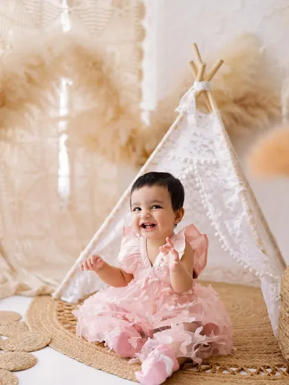 Look at that happy smile! Sitter sessions are perfect for capturing your baby's budding personality as they learn to sit up, laugh, and explore the world.