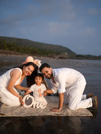 A family's first portrait, complete with sandy toes and ocean breezes. I adore taking my sessions outdoors to capture beautiful, natural light and create authentic moments like this first birthday celebration by the sea.