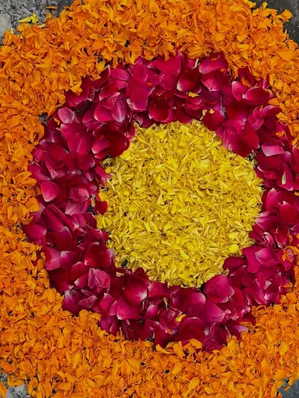 A beautiful circular rangoli made from marigold and rose petals. This is a perfect addition to any traditional ceremony.