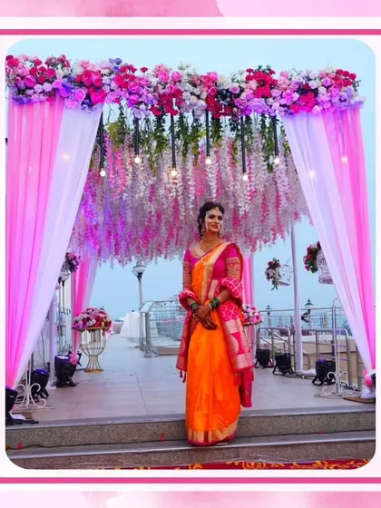 A beautiful bride framed by a pink and white floral passage I designed for a rooftop wedding. The hanging wisteria and sheer drapes create a soft and romantic entrance with a view.