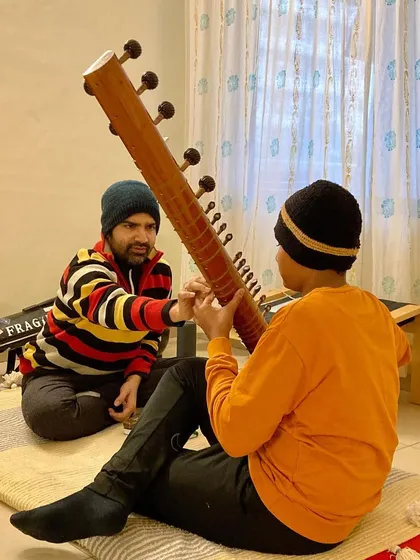 Correct posture and hand position are the first and most important lessons. I guide a new student on how to hold the sitar comfortably and correctly to build a strong foundation for their playing.