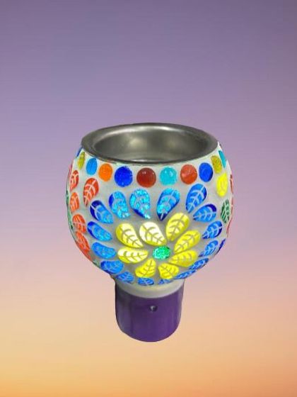 This plug-in diffuser features a lovely floral mosaic pattern with bright yellow and blue petals. It's a wonderful way to bring a touch of nature and art into your home while enjoying a pleasant fragrance.
