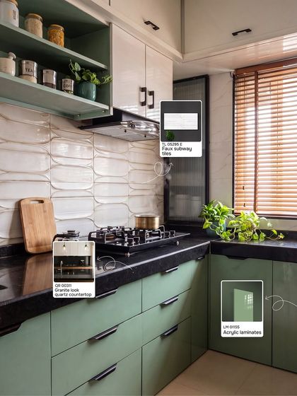 Here is a perfect example of a modern kitchen with a desi soul. I've tagged the exact materials used, from the sage green acrylic laminates to the wavy subway tiles and granite-look quartz countertop. This shows how you can get a high-end look with smart material choices that are both beautiful and practical.