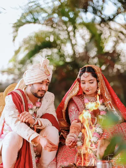 The sacred fire of the Pheras ceremony, with the couple fully engaged in the ritual. We capture these traditional moments with a focus on authenticity and detail.