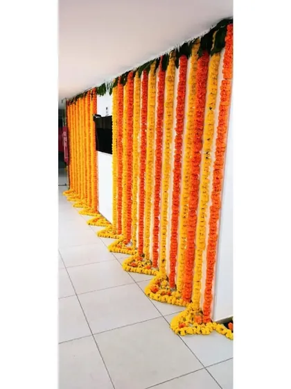 This is an example of our corporate decoration services. We decorated the Pedigree office in Jogeshwari for Diwali with long, flowing garlands of orange and yellow marigolds, bringing festive spirit to the workplace.