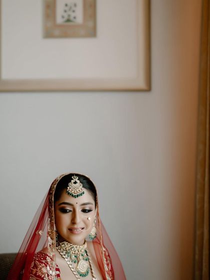 A candid moment of happiness. Even in a relaxed pose, her bridal makeup looks impeccable and radiant.