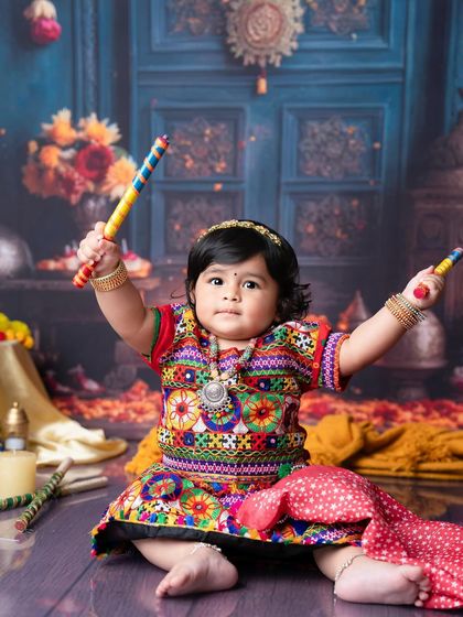 Ready for Garba night. This little girl in her colorful traditional dress is all set for Navratri with her dandiya sticks.
