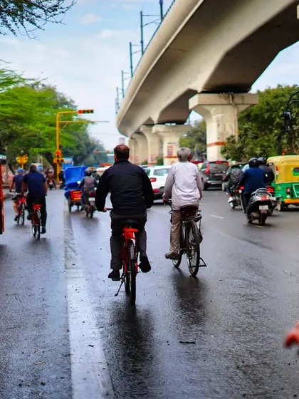 This image captures the reality of cycling in Delhi, sharing the road with buses and other vehicles. We advocate for better infrastructure to make cycling safer and more accessible for everyone.