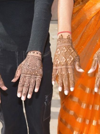 Two clients showing their complementary traditional designs. This is a great example of how I can create coordinated looks for bridesmaids or family members.