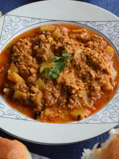 A delicious bowl of Chicken Keema with Potato, a comforting dish included in my weekly Iftar box. It's perfect with soft pav.