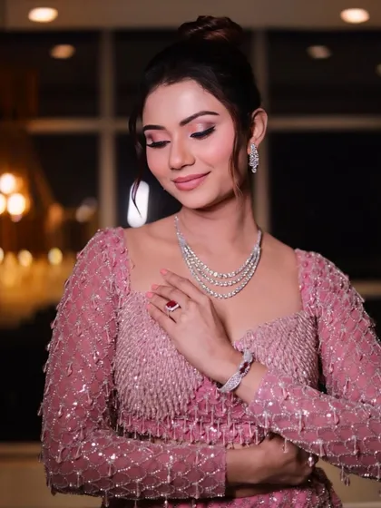 The full look, featuring a pink mermaid-style lehenga. The sleek updo and glamorous makeup complete this show-stopping ensemble.