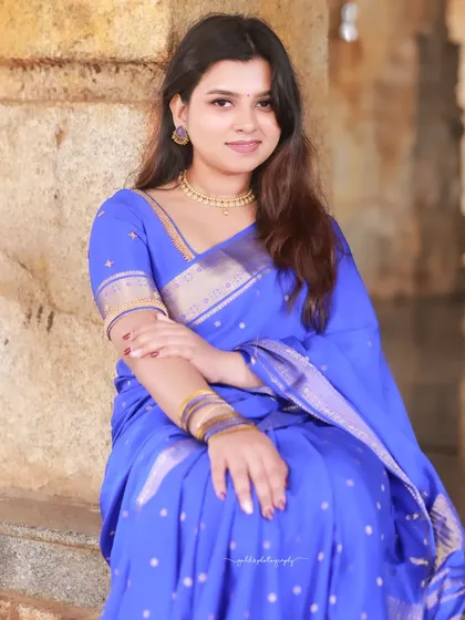 A classic seated portrait, with the bride looking directly at the camera with a gentle smile.
