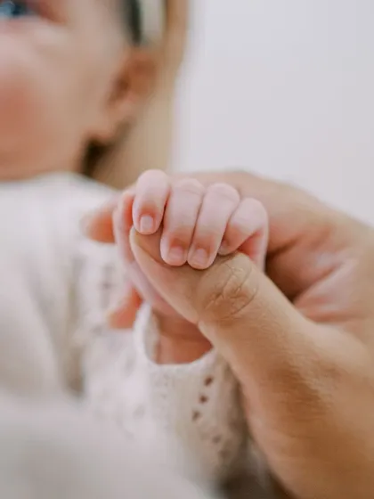 A newborn's tiny hand grasping a parent's finger. It’s these small, fleeting details that tell the biggest stories of love and connection.