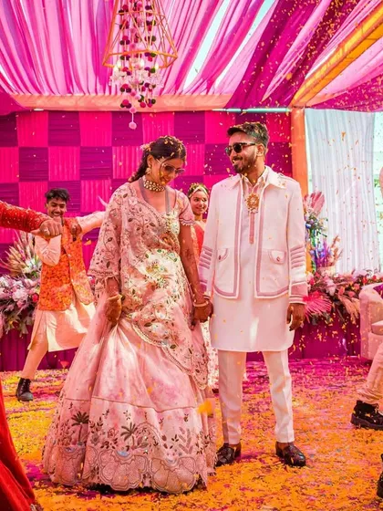 The couple's entry amidst their dancing friends and family. We choreograph these moments to feel natural, fun, and full of celebratory energy.