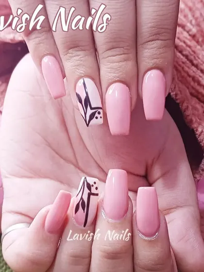 A simple yet stylish set of pink square nails with a black abstract botanical design on the accent nails.