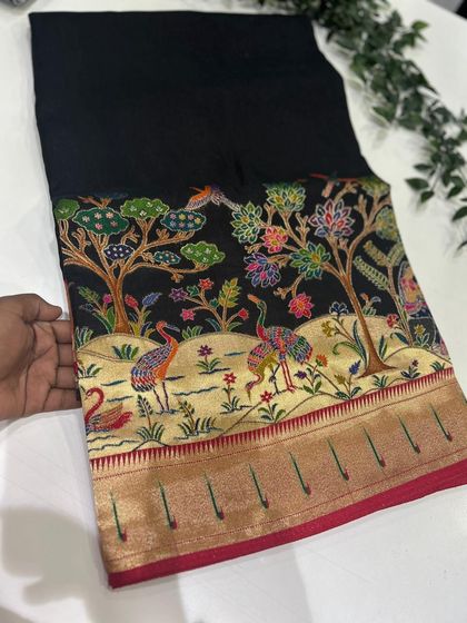 Our Dola Paithani saree in a timeless black. The vibrant, multi-colored weaving on the pallu creates a breathtaking contrast.