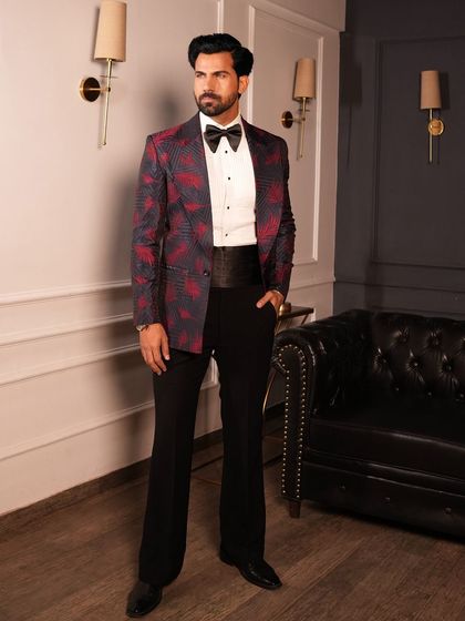 This tuxedo features a bold red and black leaf pattern, offering a distinctive look for cocktail events and wedding receptions.