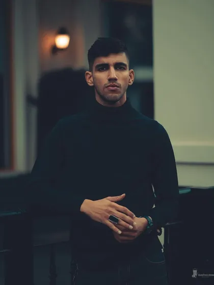 My approach to men's portraiture is the same: find the story. This moody, low-light portrait focuses on a direct, confident gaze, creating a timeless and strong image.
