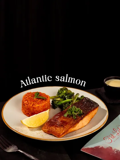 For something a little lighter, try my grilled Atlantic Salmon. It’s cooked to perfection and served with rice and steamed broccoli.