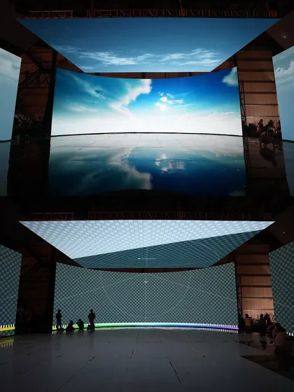 A direct comparison of our LED wall displaying the virtual sky environment versus the un-rendered grid. This highlights the technical foundation of our virtual sets before the final, photorealistic visuals are applied.