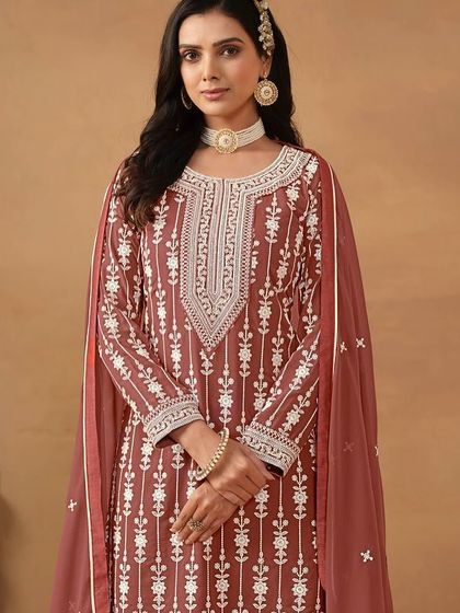 This chocolate-colored salwar kameez is rich and elegant. The all-over thread embroidery on the georgette fabric gives it a classic, timeless appeal.