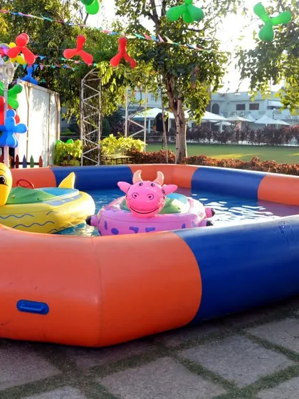 An inflatable pool with cute animal floaties, adding a fun water play element to an outdoor Angry Birds party.