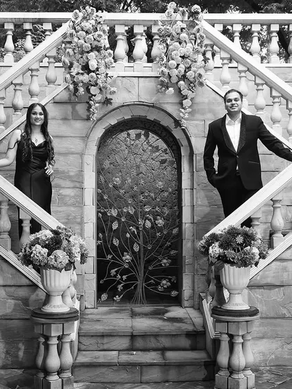 A black and white version of the grand staircase shot, emphasizing the architectural beauty and timeless feel of the pre-wedding location.