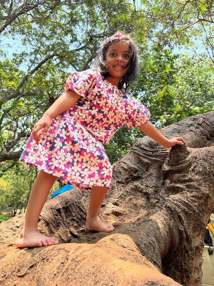 The triumphant smile of a successful climb. This young girl's expression is a mix of excitement and pride, a perfect example of the joy that comes from outdoor challenges.