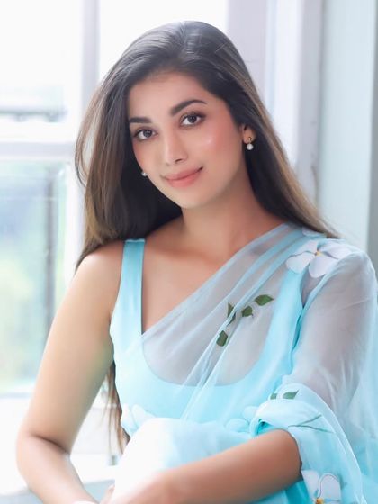 A beautiful portrait of Digangana in a light blue saree. The soft glam makeup, with its luminous finish and neutral tones, perfectly complements the serene and graceful vibe of the outfit.