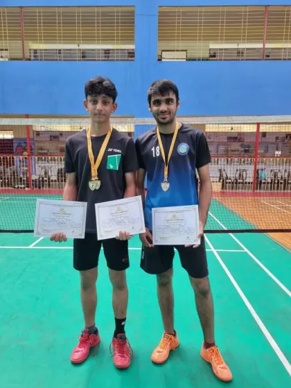 Zehn Masani and his partner with their gold medals and certificates after winning the Boys Doubles U17 event at the CISE Zone D Championship.