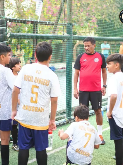A pre-game pep talk from the coach. These moments are crucial for getting the team mentally prepared and focused on the game plan.