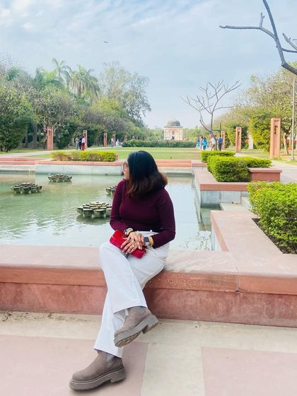 A peaceful moment in a beautiful garden. I paired a classic burgundy turtleneck with white trousers and chunky boots for a comfortable and chic look perfect for a spring day.