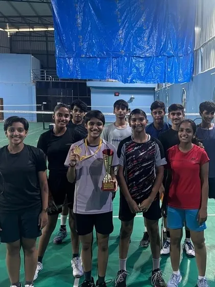 Alina Jain celebrating her CBSE Cluster gold medal win with her teammates back at the academy. The support of the team is crucial for individual success.