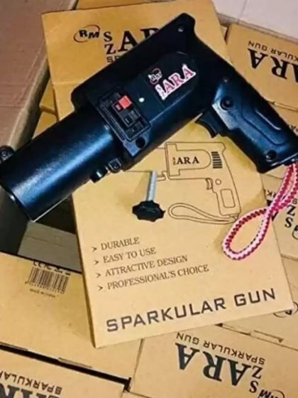 For an exciting gender reveal, I offer this handheld sparkular gun. It creates a safe, indoor firework effect that adds a dramatic flair to your big announcement.