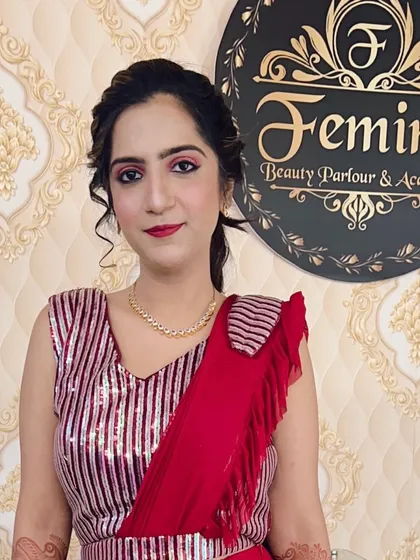 A chic and modern party look. The client is wearing a sequined red top, and I gave her a subtle smokey eye, a matching red lip, and a stylish ponytail.