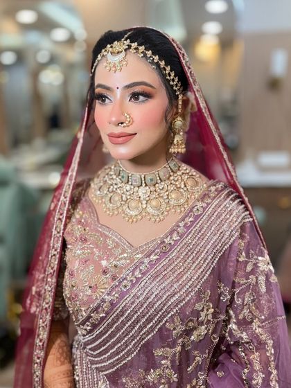 Ethereal elegance with a rose gold bridal goddess glow. This bride's unique purple lehenga was complemented with soft, shimmery makeup.