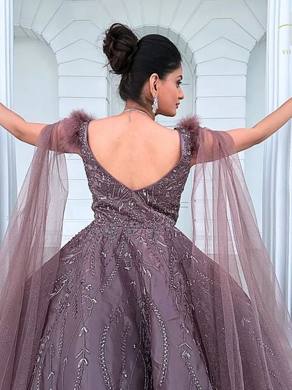 The back of this mauve gown is just as stunning as the front, with a low back and delicate feather details on the shoulders.