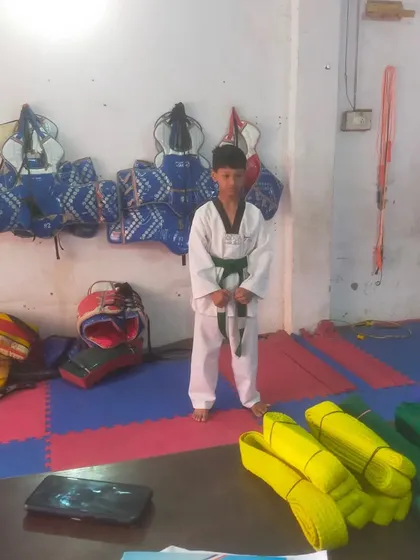 A student stands ready for his belt promotion test. The room is filled with equipment, showing our readiness for all types of training.