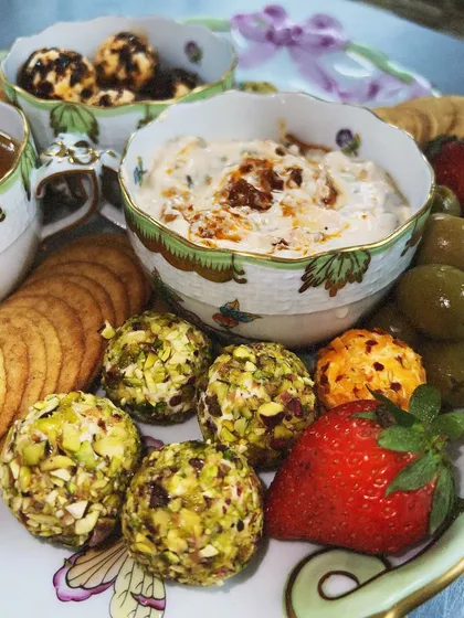 Pistachio and herb-crusted goat cheese balls, a colourful and flavourful addition to our cheese platters. The combination of creamy cheese and crunchy nuts is always a hit.