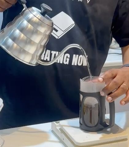 A close-up of a French press brew being prepared during our workshop. We teach multiple brewing methods to show the versatility of coffee.