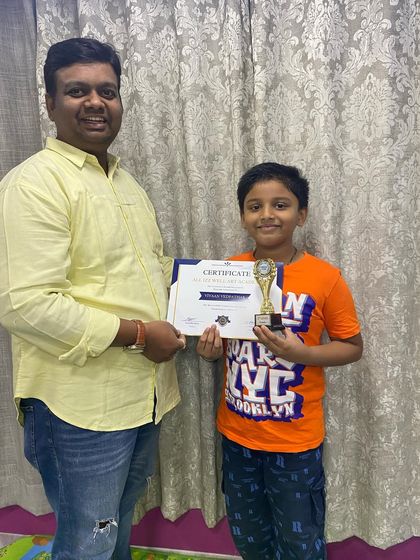 Another proud student receives his certificate and trophy for completing his abacus level. Each success story inspires us all.