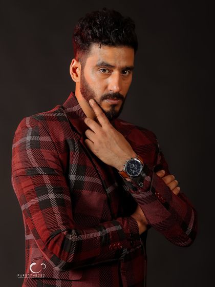 A classic, confident pose that is perfect for a professional portfolio. The lighting is sharp, highlighting his features and the texture of the suit.