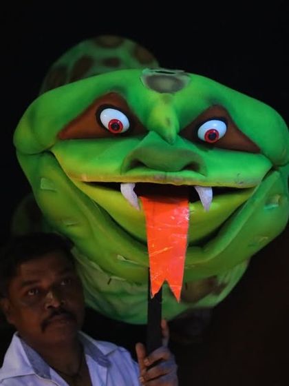 A large snake puppet being operated for the "Ardhavatrao 100 Not Out" show. We use different types of puppets, including rod puppets like this one, to create diverse characters.