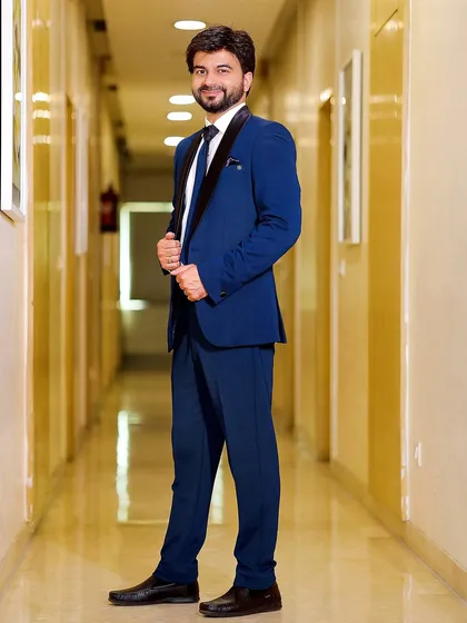 A full-length shot of the groom in the hallway, looking confident and happy. A great way to capture the groom's style.