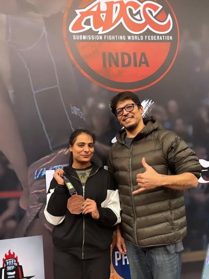 A student and coach celebrating a bronze medal win. Every competition is a learning experience, and we are proud of her for stepping up to the challenge.