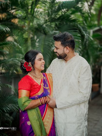 A candid moment of laughter and love. The couple shares a joke, their genuine smiles making this a heartwarming and authentic engagement photo.